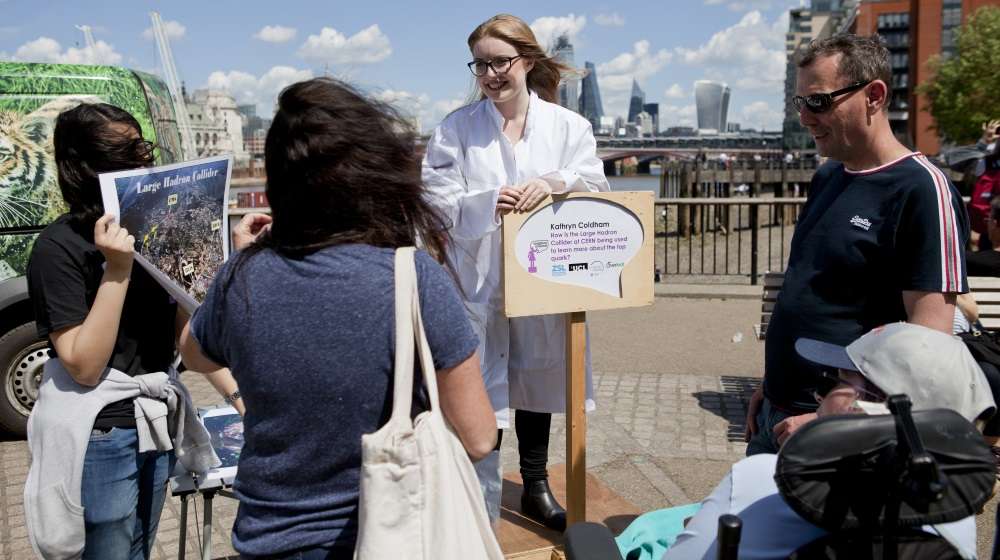 A female scientist talks to an audience at the Soapbox Science event in London
