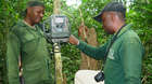 Thierry (right), monitoring officer for ZSL’s conservation project in the park, with a ranger. He is showing him how to install the camera trap.
