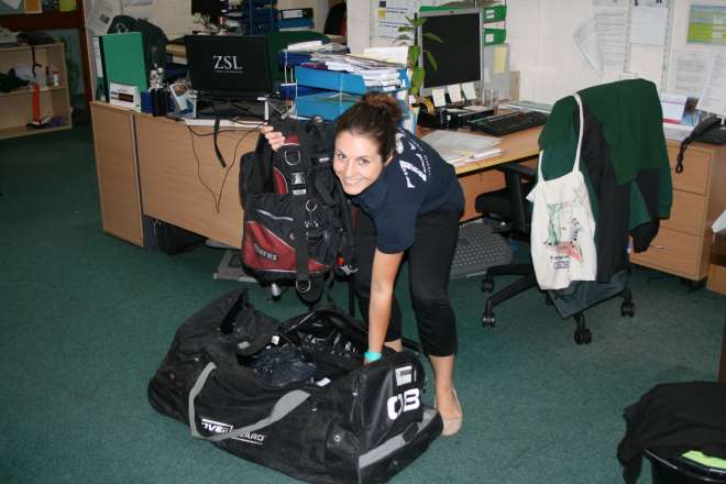 Photo of Ana packing her scuba equipment into her bag