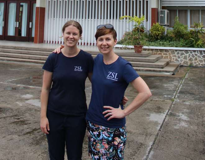 Olivia and Rachel stand outside the University of Seychelles building