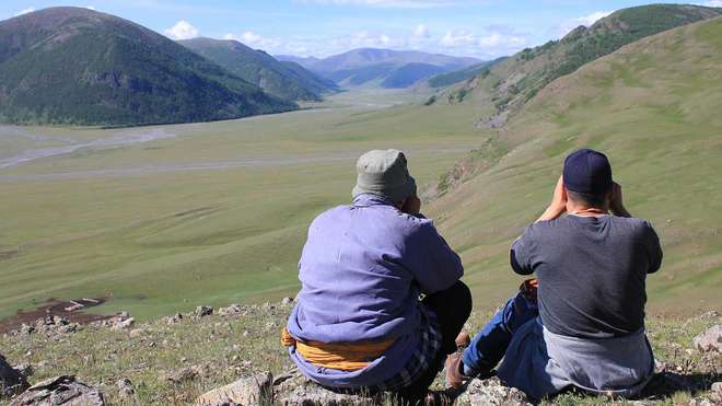 Two people looking at the mountain landscape