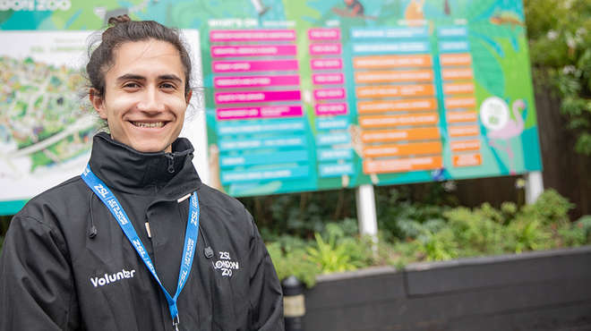 staff member at London zoo wearing uniform and smiling