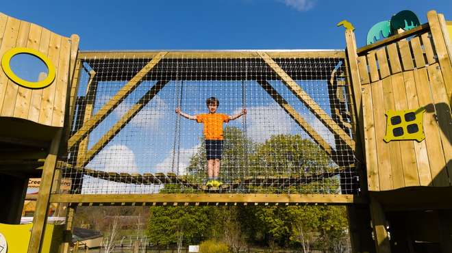 A little boy on a bridge in Hullabazoo Adventure Play at ZSL Whipsnade Zoo