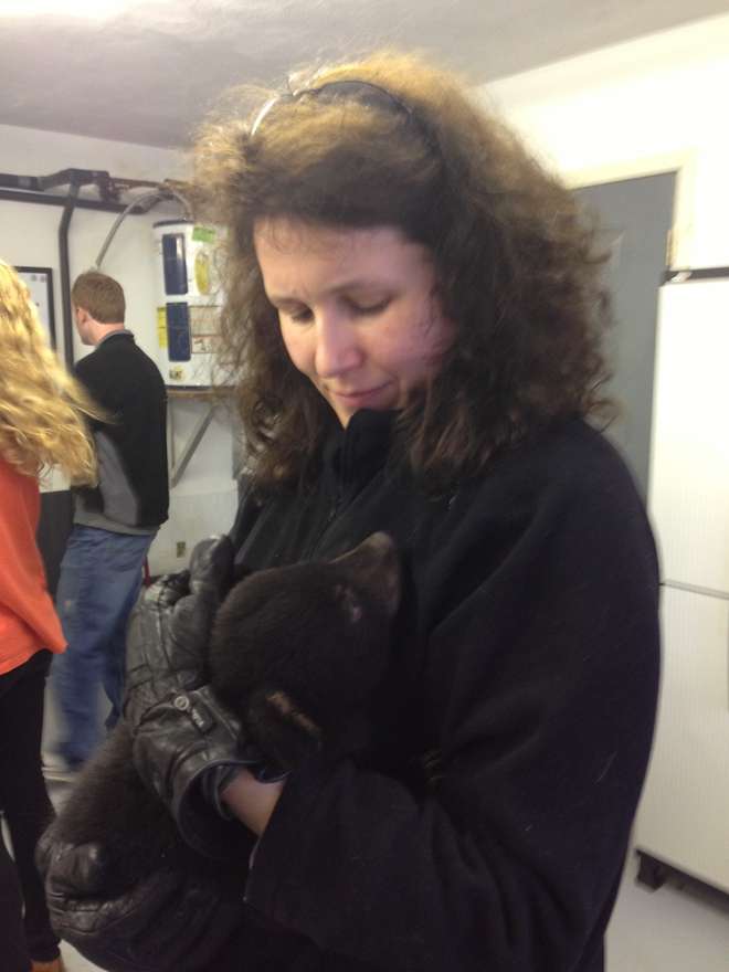Nathalie Pettorelli holding a bear cub.