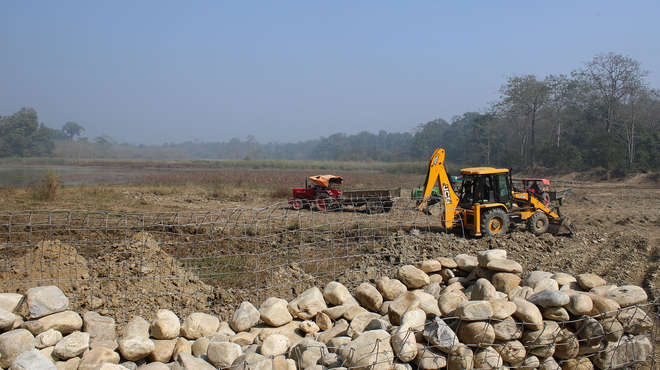 Photograph of tractors and diggers clearing the lakeside
