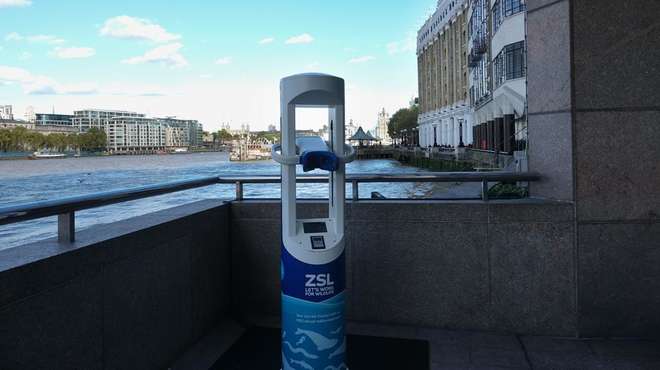 Photo- Thames Virtual Reality unit on the walkway by the Thames, with London's skyline in background
