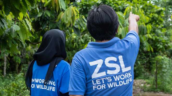 Two ZSL conservationists pointing to the distance
