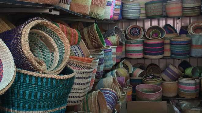Photo - Several shelves filled with many colourful, hand-woven baskets
