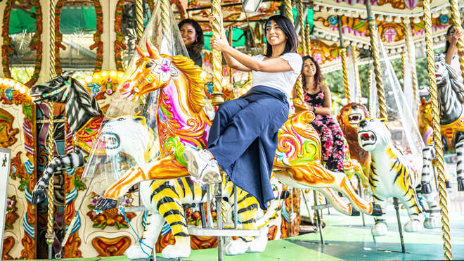 girls riding a carousel