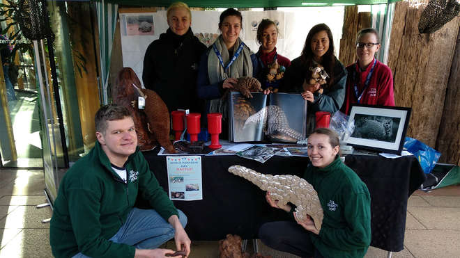 group of people posing at a pangolin information stall