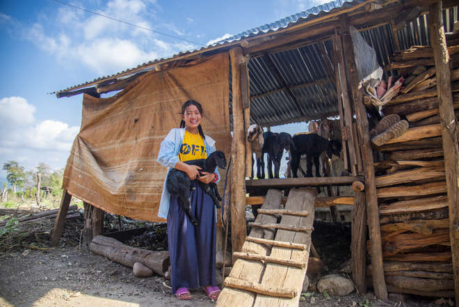Nepalese woman with her predator-proof corral facilitated by ZSL Nepal